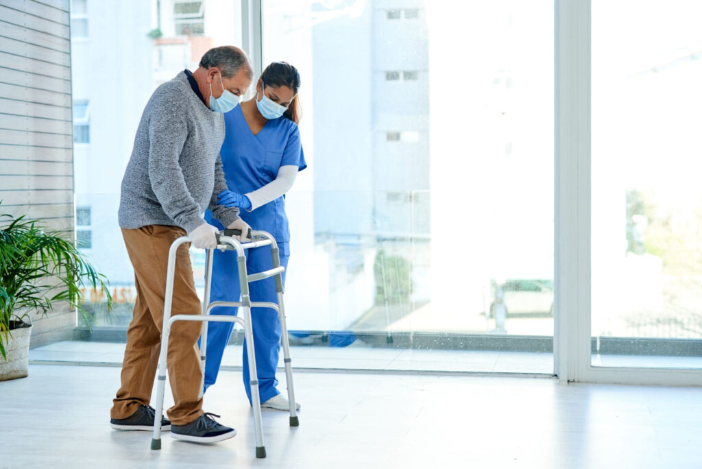 A doctor helping patient to walk
