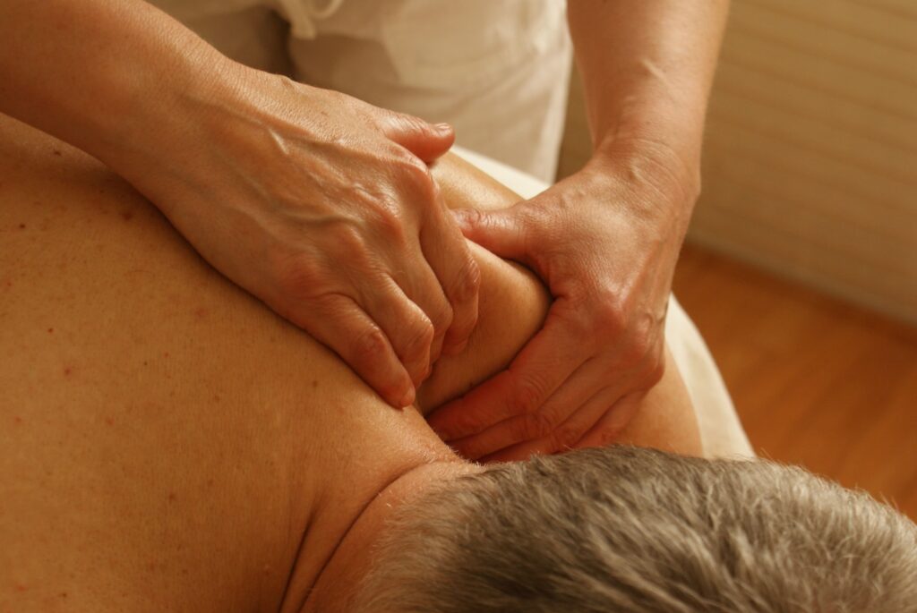 An old man getting massage therapy
