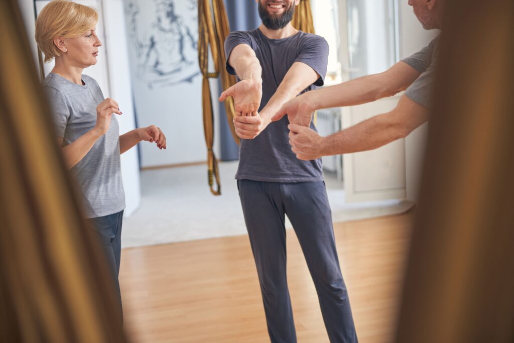 People performing finger stretch exercises to help recover from a brachial plexus injury.