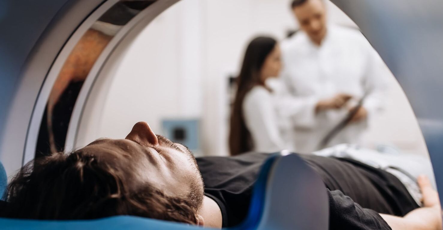 Male patient lying down during CT scan procedure