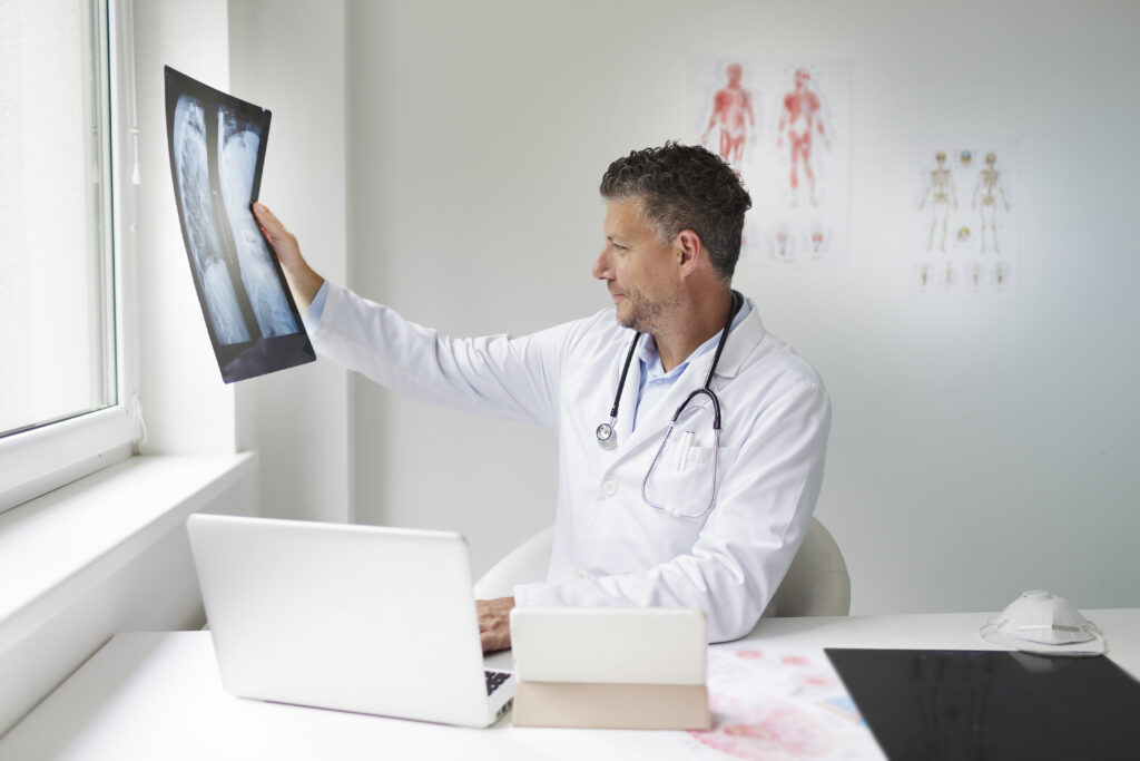 doctor reviewing a spine surgery second opinion report