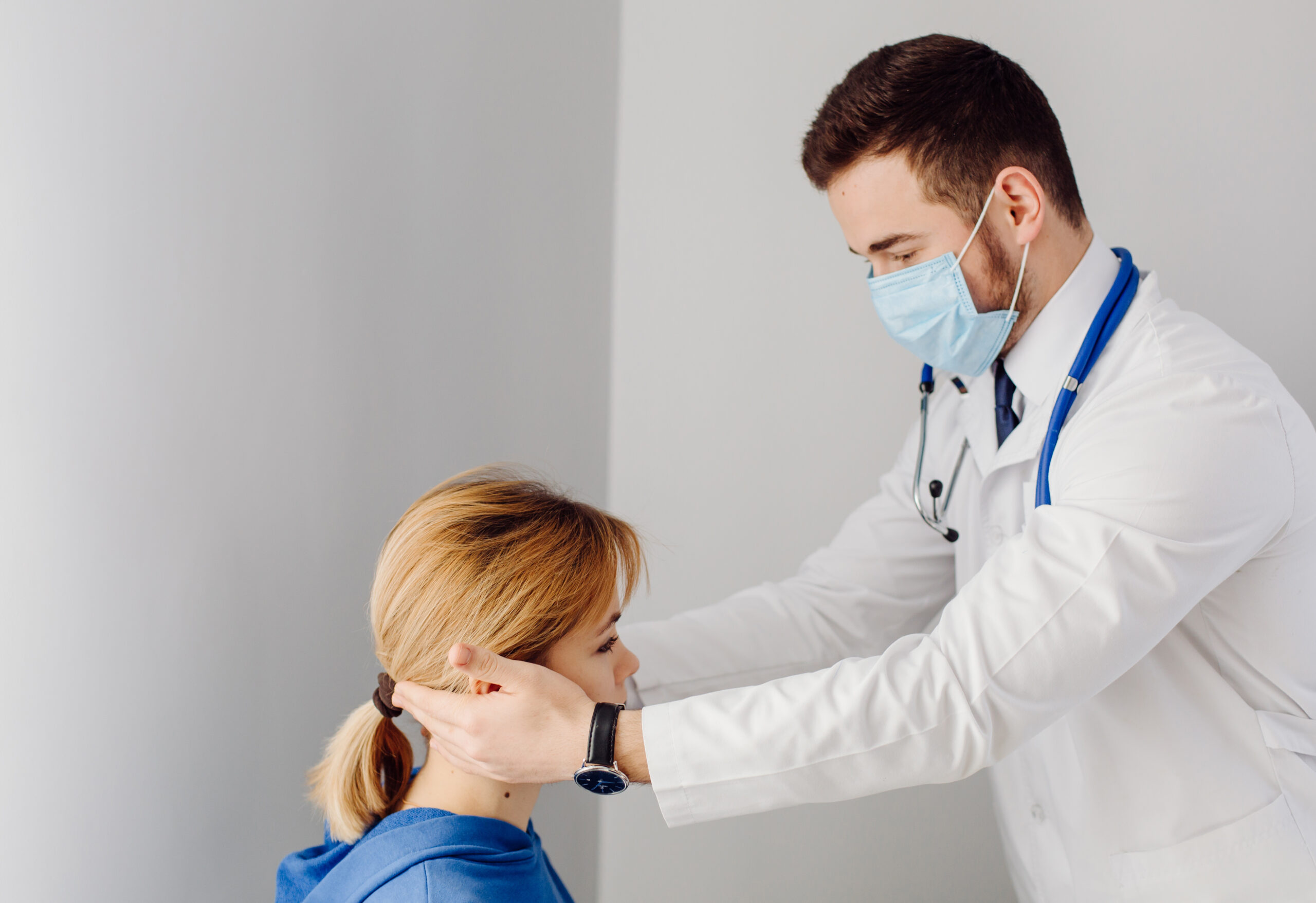 Orthopedic surgeon for neck pain reviewing imaging with a patient.