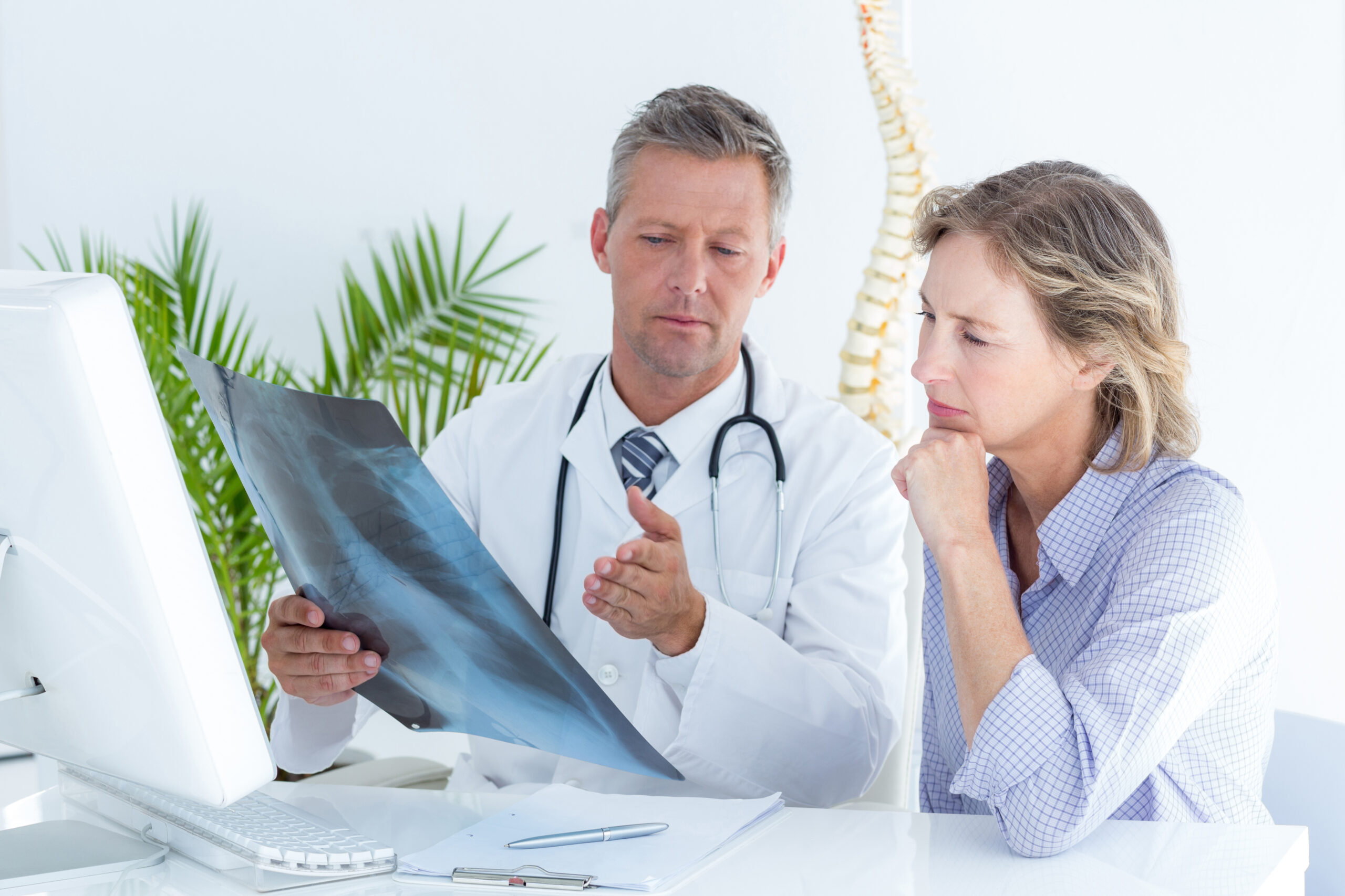 Consultation room with the best spine surgeon in southern california reviewing MRI.