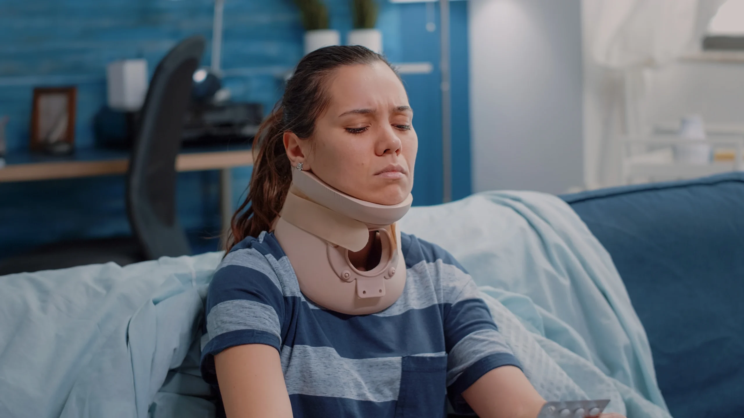 Woman wearing cervical collar during recovery after cervical spine surgery neck performed by best spine surgeon in Los Angeles.